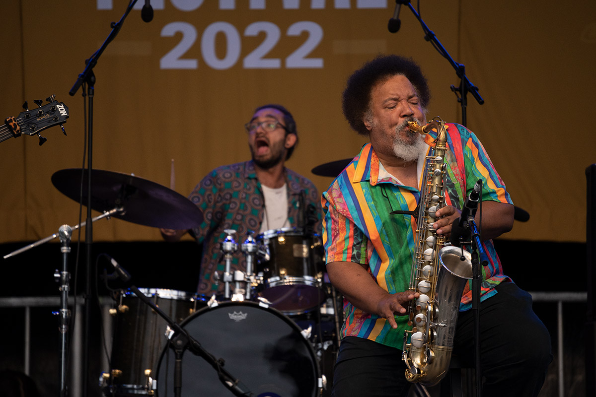 Drummer and saxophonist on stage.