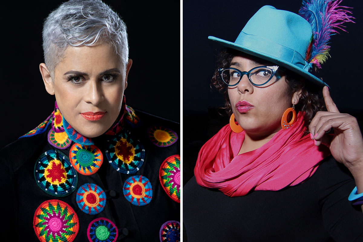 Two women, both in black clothes with colorful accents (embroideries, fuchsia scarf, blue fedora with feathers).