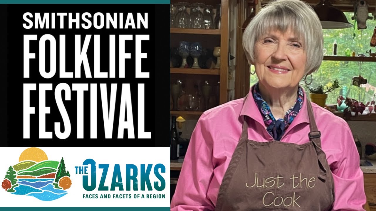 A woman in an apron smiles.