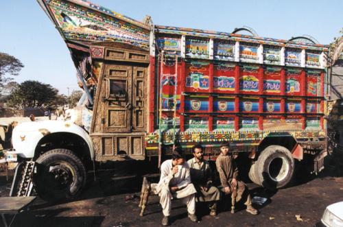 This colorfully painted truck in Pakistan includes elaborately carved wood. Nomadic artists do similar fine work to decorate camels.