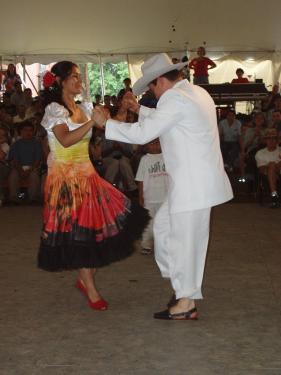The joropo dance from the plains of Colombia boasts elaborate footwork to the rhythm of the small four-stringed cuatro guitar. Ana Veydó Ordóñez steps quickly to her partner's rhythmic stomp.