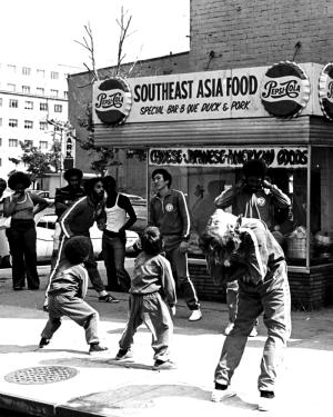 Members of Willy Lin's Kung-fu School loosen up before class at the corner of Sixth and H Streets in Northwest Washington, ca. 1971. At this time, the local Asian Pacific American community was represented by restaurants that spanned more than one nation 