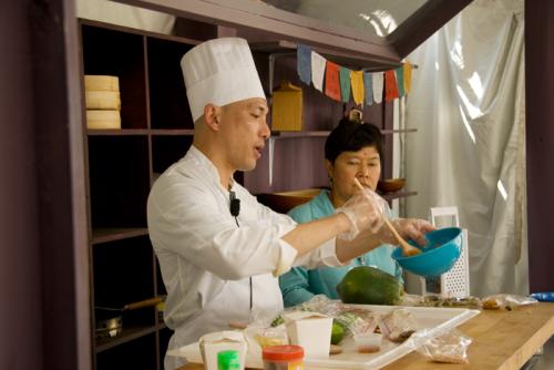 John Tin Pe, who with his mother owns and operates the Burma Restaurant in D.C.&rsquo;s Chinatown, gives a cooking demonstration with the help of presenter Ang Robinson at the 2010 Smithsonian Folklife Festival.