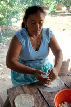 Alejandra Vera makes corn tortillas by hand at lunchtime in the communal lands of Santa Rosa Xtampak, Campeche.