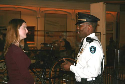 Security Supervisor Perry W. Singletary assists a visitor to the National Air and Space Museum's exhibition on the Wright Brothers and the Invention of the Aerial Age.
