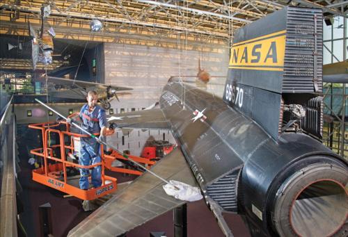 Harrison Jones, a member of the objects cleaning crew at the National Air and Space Museum, dusts the X-15 aircraft hanging in the Milestones of Flight Gallery.