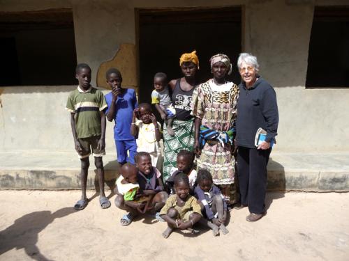 Olga Linares, an anthropologist with the Smithsonian Tropical Research Institute, studies changes in rice production and the future potential of the crop. She is pictured here with a Jola family in Senegal.