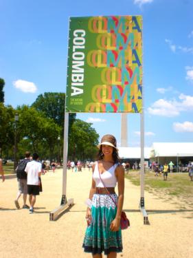Kiley Guyton Acosta in front of the 2011 Smithsonian Folklife Festival Colombia program sign and the Washington Monument.