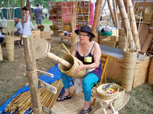 &larr; Dora Flor Alba Brice&ntilde;o working on a basket.