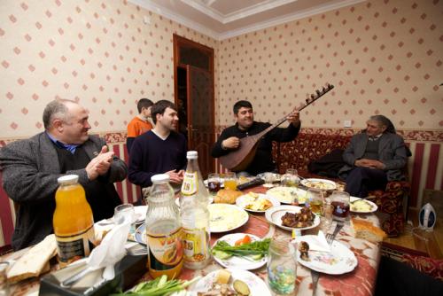 Peace Corps volunteer Tim McNaught eats, drinks, and socializes with his host family in Azerbaijan.