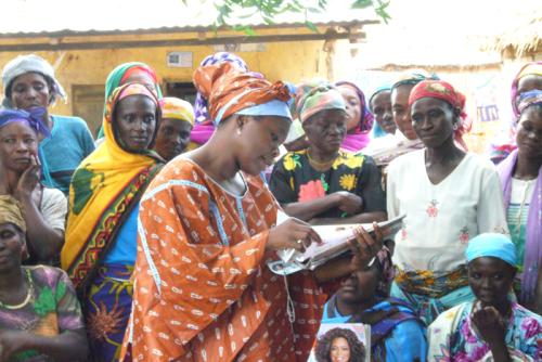 Rahama Wright (center) meets with some of the women in northern Ghana who produce shea butter for cosmetic products.