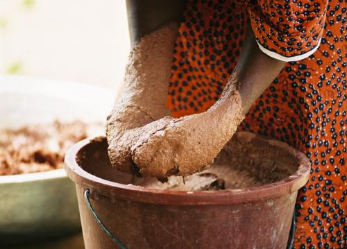 After shea nuts have been crushed, roasted, and ground, they are mixed by hand, while water is slowly added to create a smooth paste.