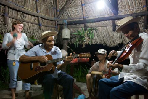 Katie Simpson, a Peace Corps volunteer in Panama, works with an environmental group to inform the public about the protection of sea turtles. She also plays the maracas with a local band.