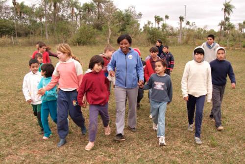 Peace Corps volunteer Tara Taylor walks with her students in Paraguay.