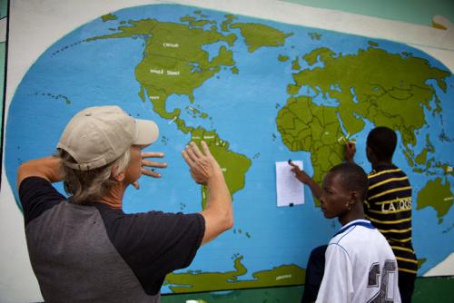 Peace Corps volunteer Edward Solem and the world map drawn by his students in Liberia.