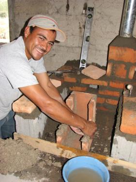 In Guacerique, Honduras, Victor Manuel Avila Gonzales builds a ceramic combustion chamber for a fuel-efficient cookstove. By containing and directing the flame, the combustion chamber may reduce firewood usage by up to 70 percent.