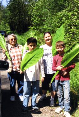 Youth from Theodore Jamerson Elementary School, based at the United Tribes Technical College, plant fruit trees.
