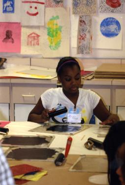 Partners-in-Art participant Jai Braggs from Hamilton Middle School prepares to ink a Hungry for Art/ART FOR HUNGER printing plate.