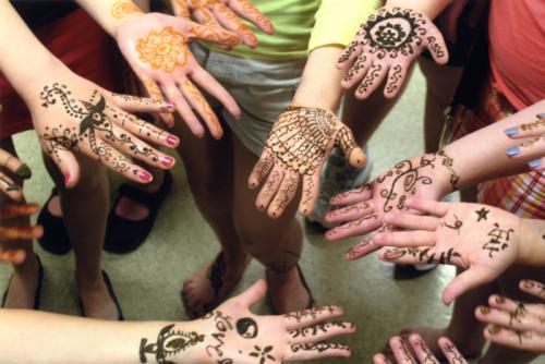 Traditional art adorns the hands of FOLKPATTERNS participants.