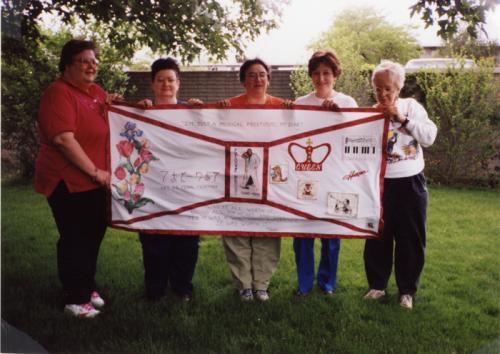 Sarah Leigold, Carol Hunterton, Sharon Fetter, Linda Neel, and Darien Duck hold the panel they made for Freddie Mercury, block 02442.