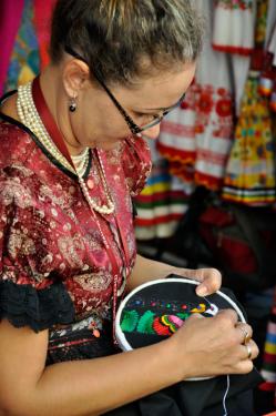 Bernadett Papp from Mez&otilde;k&ouml;vesd in northern Hungary displays her embroidery skills at a festival in 2011. Mez&amp;otildek&ouml;vesd is celebrated for its contemporary folk art, especially folk costume and embroidery.