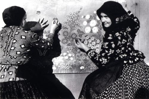 Women of Kalocsa decorate the walls of their house in the late 1930s, much as they do today.