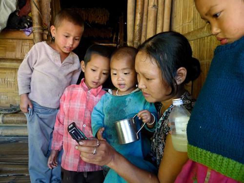 Yaro Richo watches a video recording of a Koro song with children in Kaj&otilde; village, East Kameng District, Arunachal Pradesh, India.