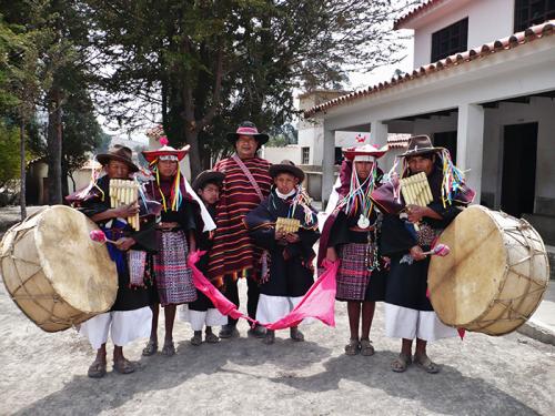 Roberto Sahonero, the director of Los Masis, stands together with local musicians and students from the bilingual Quechua-Spanish school that Los Masis helped to establish in the rural community of Miskhamayu, Bolivia.