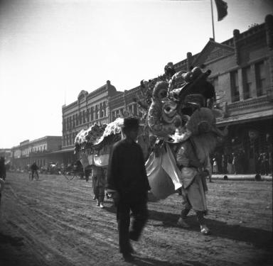 A dragon dance group takes a break as they process down North Los Angeles Street during the local Chinese community' New Year's celebration, Los Angeles, ca. 1902.