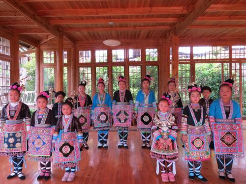 Young singers pose in traditional clothing.