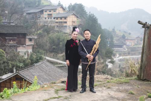 (L to R) Li Lingting and Mo Ming, a <i>lusheng</i> player and maker, pose in their village in Leishan County, Guizhou Province, 2014.