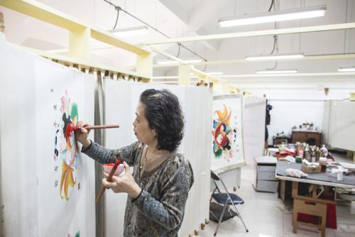 Chen Yuhua specializes in hand-painting additional color to the New Year&rsquo;s prints after they have been printed.