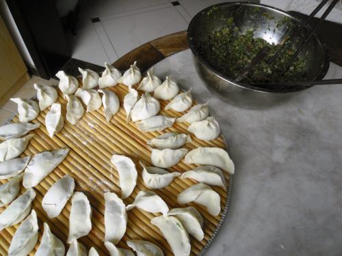 Freshly wrapped dumplings await boiling.