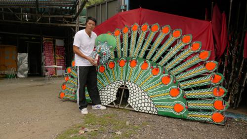 Choi Wing Kei shows some of the decorations that will adorn the flower plaque at the Smithsonian Folklife Festival, Hong Kong, 2014.