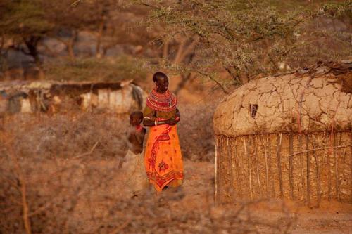 A Samburu woman walks with a boy in the village of Ngutuk Ongiron, Westgate Conservancy.
