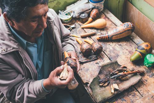 Master gourd craftsman Ponciano Canto uses a burning technique to bring his etchings to life with a range of brown and black tones.
