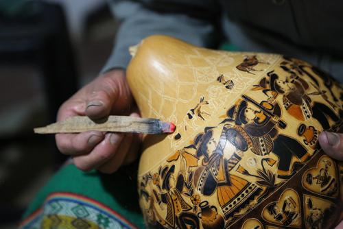 Eleuterio Medina, a mate burilado artist, demonstrates the burning techniques he uses to bring his intricate engravings to life in Cochas Grande, Huancayo. 