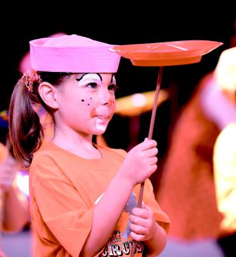 A first-grade student spins a plate in the Circus Sarasota Big Top with the Build-a-Circus program.