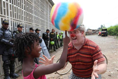 Michael O'Neill performs for a child in a settlement in Colombia.