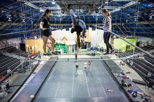 Students at Circus Juventas rehearse high above the gym floor.