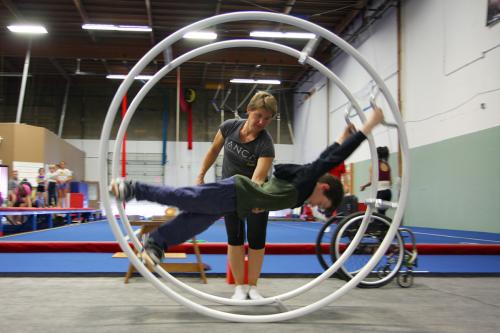 SANCA founder Jo Montgomery teaches German Wheel to a student who has spina bifida.