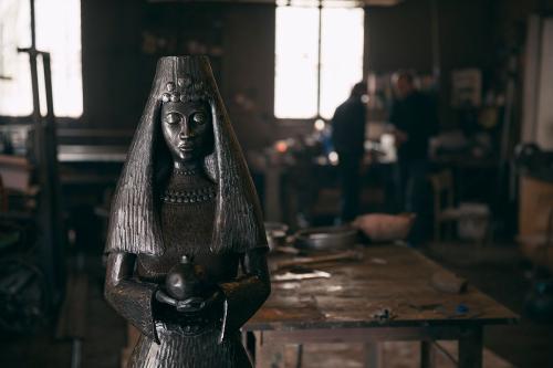 Mnoyan seeks to move blacksmithing from craft to art, sculpting pieces like this woman holding a pomegranate. 