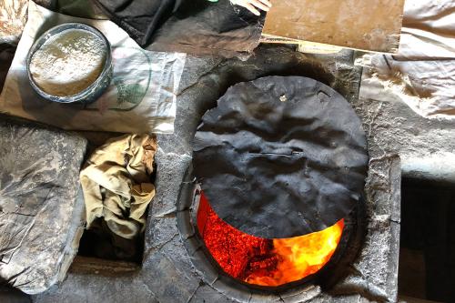 Heating the tonir (oven) with fire for lavash (flatbread) baking.