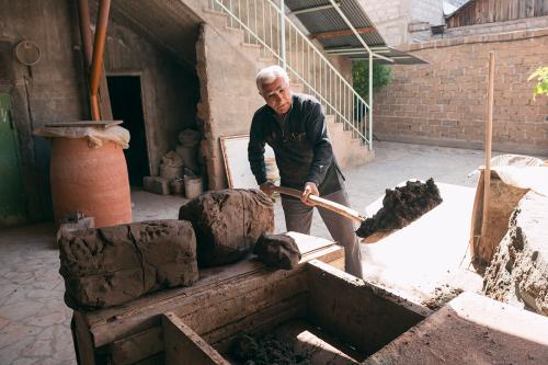 Gegham Gharibyan prepares clay for making a tonir.