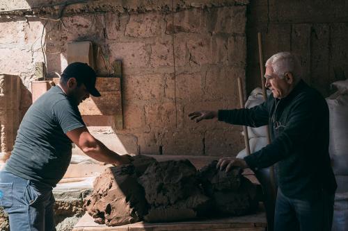 The tradition of making tonir has passed through generations of the Gharibyan family. Here Gegham and his son prepare the clay.
