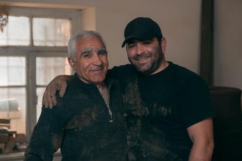 Gharibyan and his son pose for a photo after finishing a tonir.