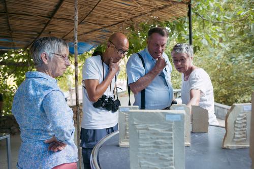Tourists look at the Ghazaryans’ finished khachkar pieces, made smaller for ease of travel. 