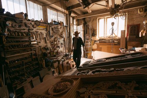 Stone carver Bogdan Hovhannisyan enters his workshop in Vanadzor.