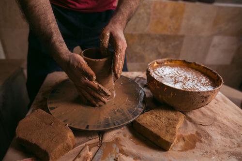 Sculpting a vessel using the wheel method. 