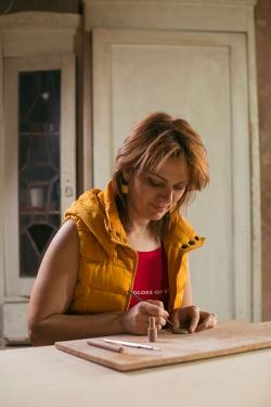 Hambardzumyan’s wife, Zara Gasparyan, an artist, works on a new line of jewelry she has created using clay.